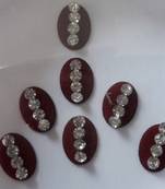 7 long oval shape maroon bindi with silver decorations