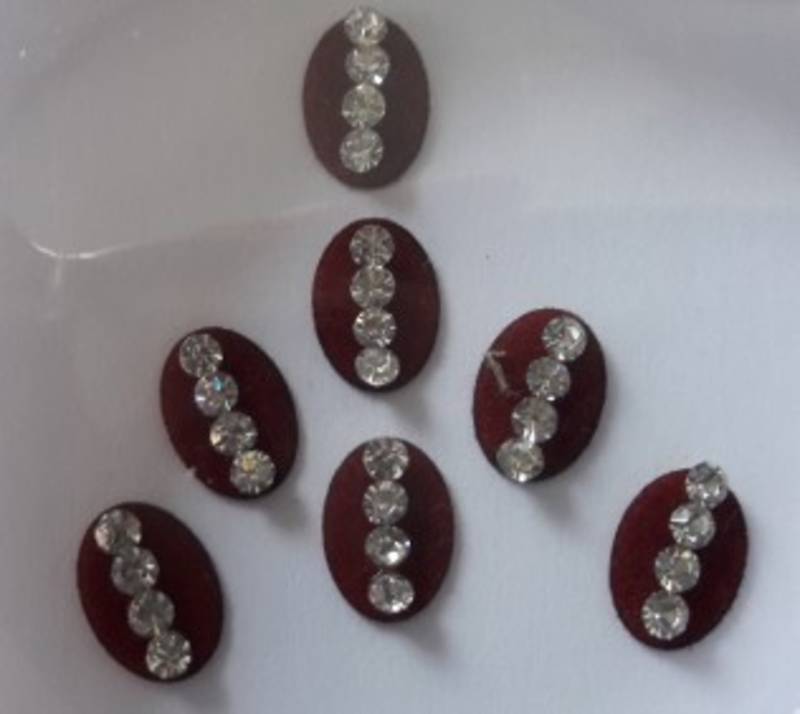 7 long oval shape maroon bindi with silver decorations