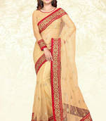 Beige embroidered net saree with blouse
