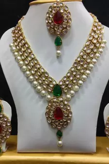 Dazzling Kundan Set in Red and Green with Pearls