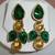 Beige n green ear ring.