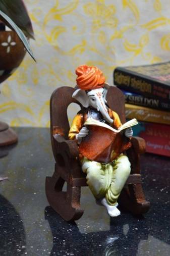 Lord Ganesha reading Book on Wooden Chair