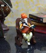Lord Ganesha reading Book on Wooden Chair