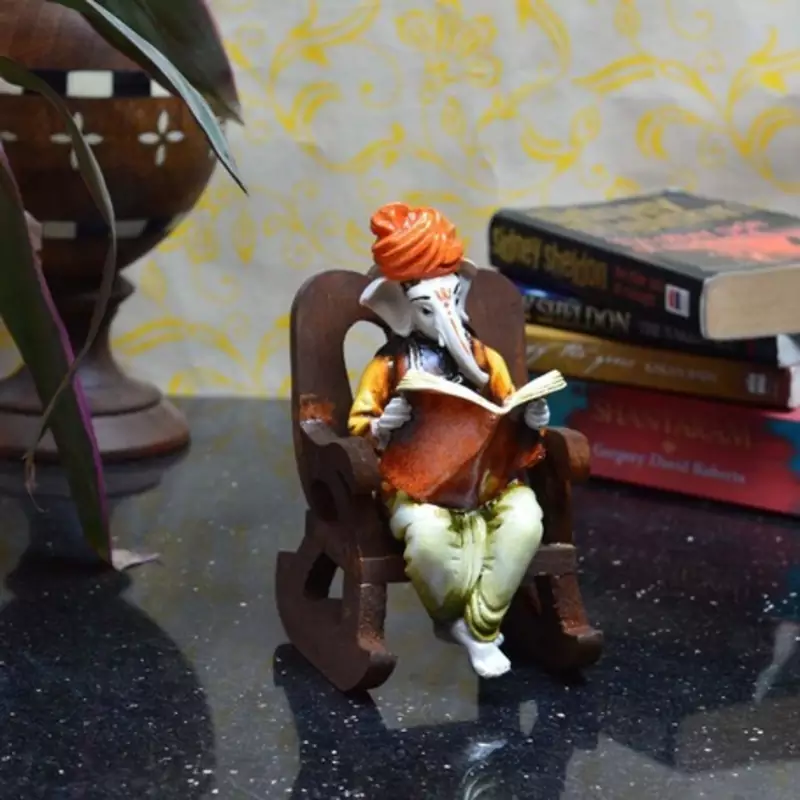Lord Ganesha reading Book on Wooden Chair
