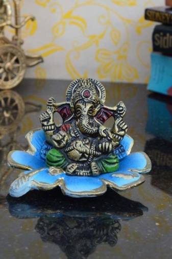 Metal Lord Ganesha Statue on Sky Blue Leaf