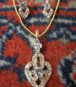golden diamond pendant with matching earrings