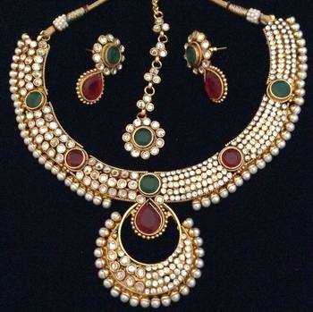 Dazzling polki with festive stonework India maroon green pearl necklace set 1
