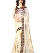 Beige embroidered net saree with blouse
