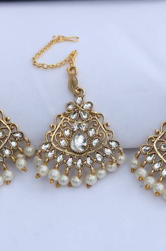  White stone studded and white pearl embellished earrings with maang tikka set for women