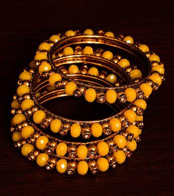 Dark yellow beaded and zircon stone embellished two pairs of designer bangles for women 1