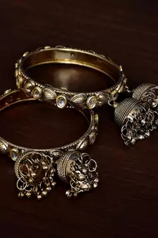 Gold Plated Kundan Embellished Pair of Designer Bangles with Multiple Hanging Jhumkis and Bells