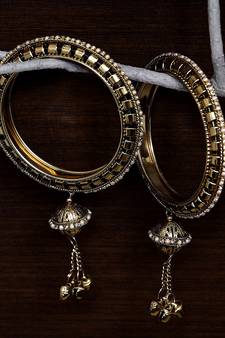 Gold Plated Zircon Stone and Seed Pearls Embellished Pair of Bangles with Hanging Bells