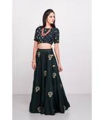 Bottlegreen raw silk lehenga with zardozi and tikki and rani pink contast georgette dupatta