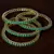 Emerald Stone Embellished Brass Made Two Pairs of Designer Bangles
