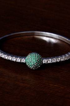 Rhodium plated emerald stone and diamond embellished light weight bracelet