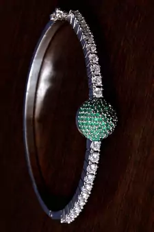 Rhodium plated emerald stone and diamond embellished light weight bracelet