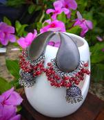 German Silver Jhumka With Water Drop Stud And Red Pearl Embellishments