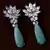 Black Gold Plated Sea Green Stone and American Diamond Embellished Designer Danglers 216ED232