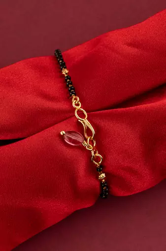 Black beads bracelet with ruby bead hanging one gram gold