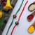Red Green Handcrafted Kundan Inspired Meenakari Rakhis (Set Of 2)