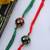 Red Green Handcrafted Kundan Inspired Meenakari Rakhis (Set Of 2)