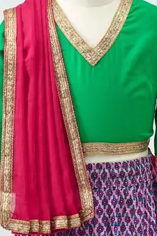 Purple printed Lehenga with contrast green tie back choli and Pink Dupatta