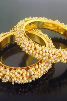 Gold pearl bangles and bracelets