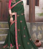 Dark green embroidered georgette saree with blouse