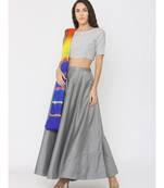 grey lenin blouse paired with silk skirt and blue shibori duppatta