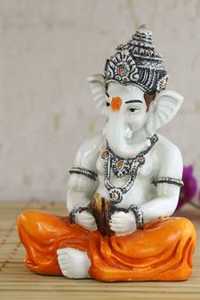 Lord Ganesha playing Manjeera Decorative Showpiece