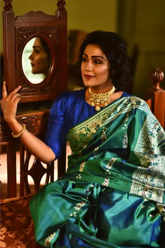 Royal, majestic Baluchari saree in a dual tone of blue-green