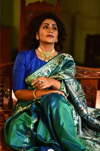 Royal, majestic Baluchari saree in a dual tone of blue-green