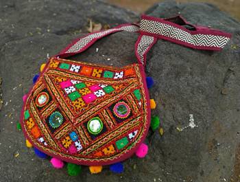 Real Mirror Worked Matka Shaped Kutch Embroidered Banjara Jhola Bag With Multicolored Pompoms All Around 4