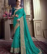 Dark turquoise embroidered chiffon saree with blouse