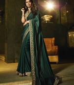 Dark green embroidered silk saree with blouse