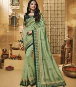 Green embroidered silk blend saree with blouse