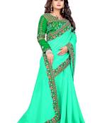 Dark green embroidered silk saree with blouse