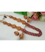 Mezmerizing Matt Gold Finish Kemp Stone Lakshmi Haaram With A Pair Of Matching Jhumkas