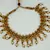 Women Gold-Plated Pink & Green Stone Studded Handcrafted Temple Jewellery Set