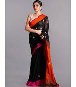 black linen saree with polka dots and orange pallu