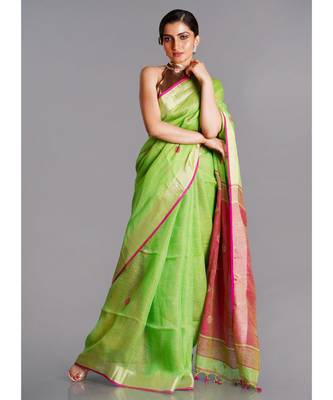 green linen saree with polka dots and pink pallu 1