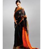 black linen saree with polka dots and orange pallu