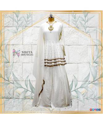 This off white dress has a peplum top with antique handwork done in three layers with a banarasi skirt 1