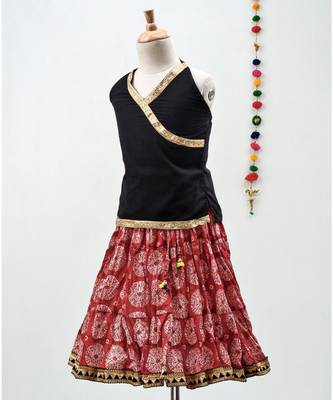 red and black cotton printed lehenga with a contrast choli and a golden lace 3