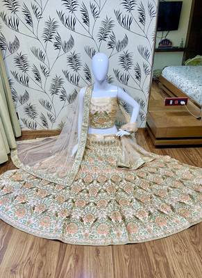 Peach embroidered satin semi stitched bridal lehengas 1