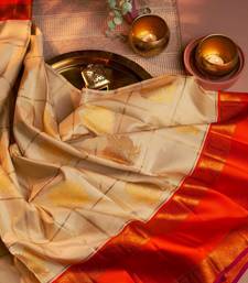 Cream woven kanchipuram silk saree with blouse