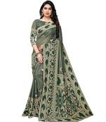 Dark green woven lycra saree with blouse