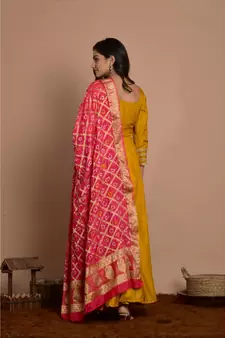 Tangerine yellow anarkali with peach gharchola dupatta