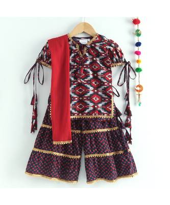 ikkat print red kurti with a dotted black and red triple layered sharara and red dupatta 3