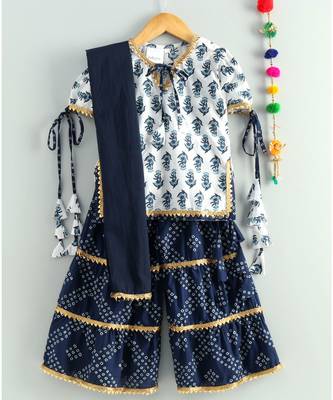 white printed kurti with a triple layered bandhini sharara and a blue dupatta 1